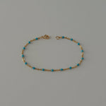 Dainty beaded bracelet crafted from gold filled satellite enamel chain.