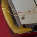 vintage mini gucci charm pendant necklace. black and gold.