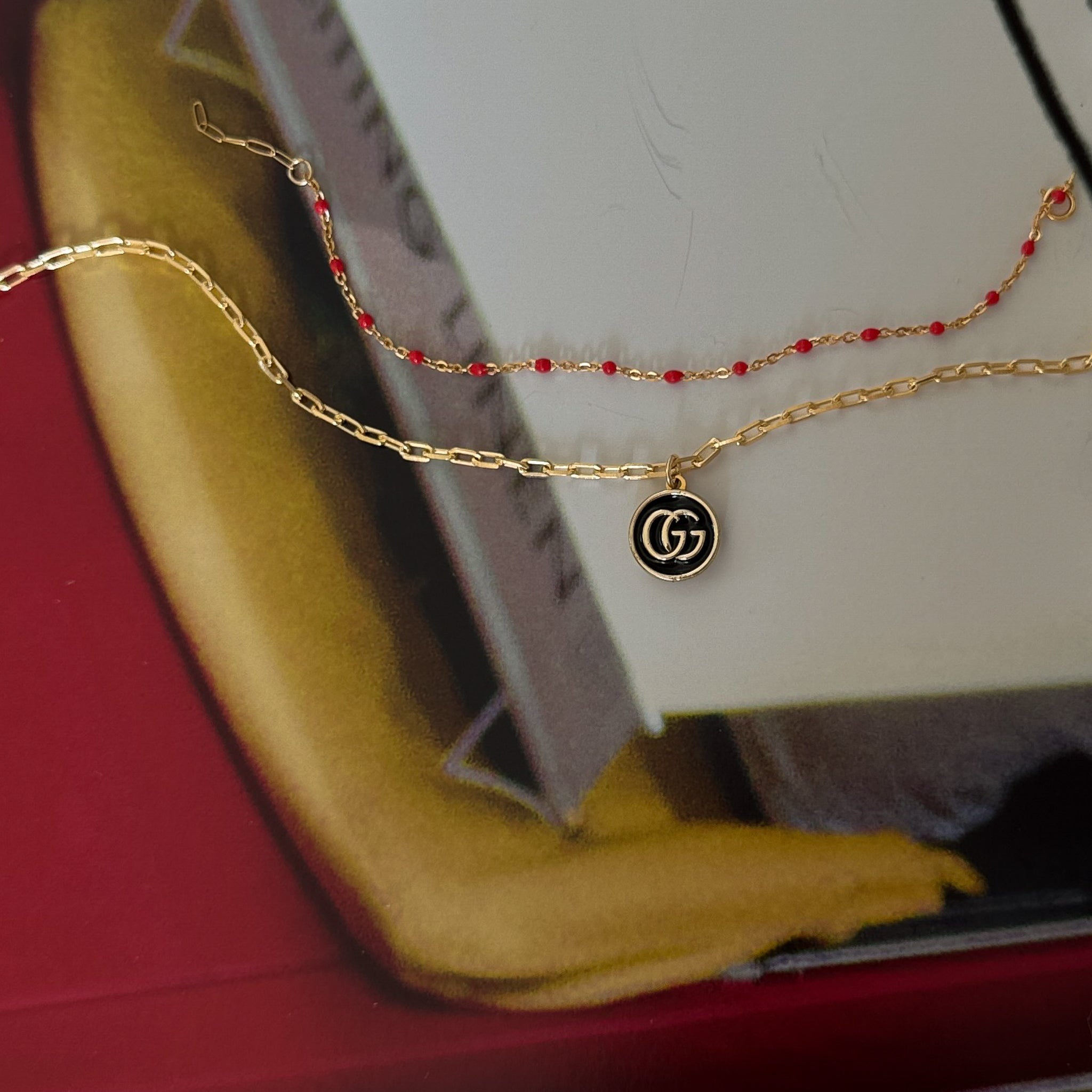 vintage mini gucci charm pendant necklace. black and gold.