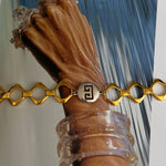 gold and silver givenchy chain bracelet on wrist
