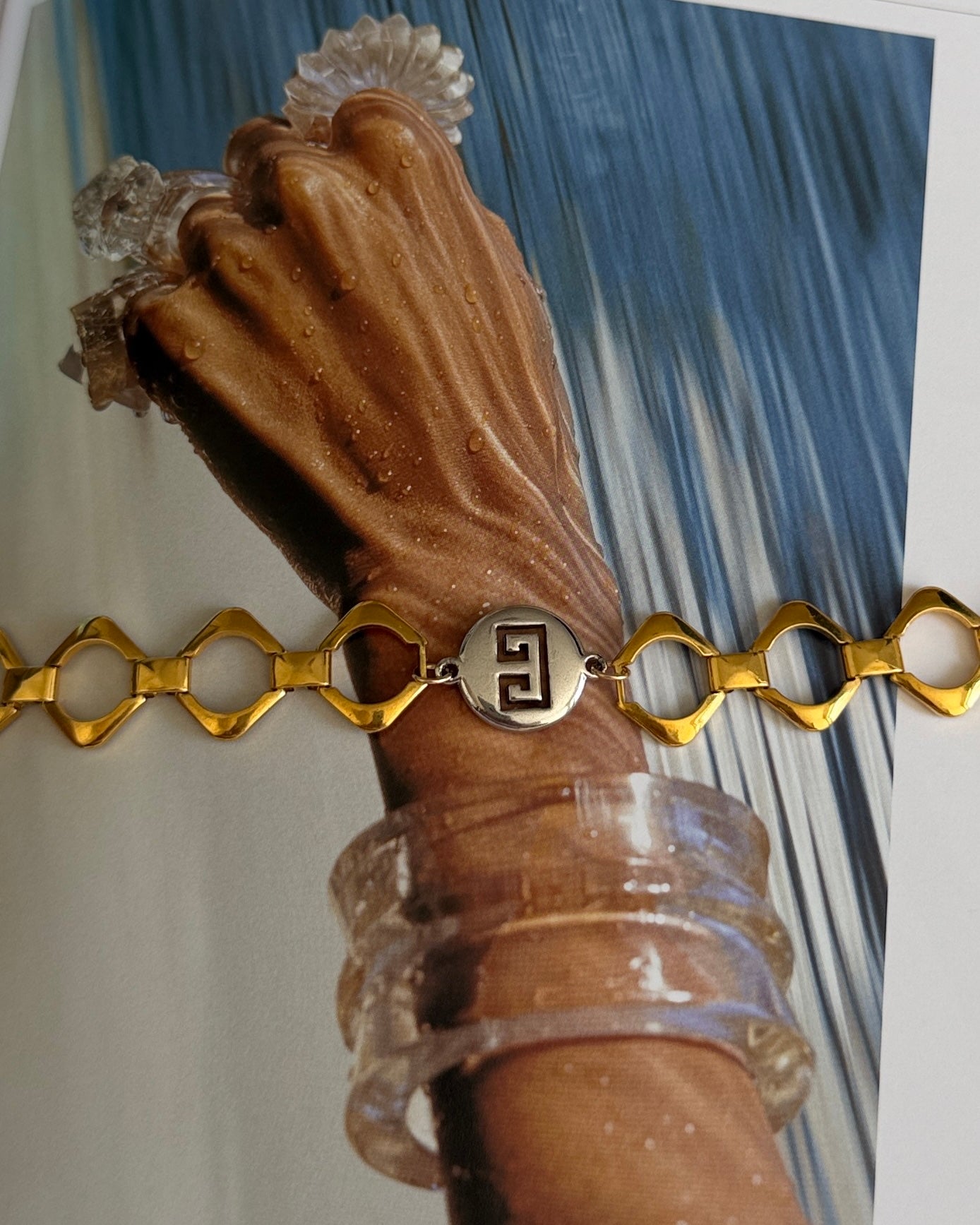 gold and silver givenchy chain bracelet on wrist