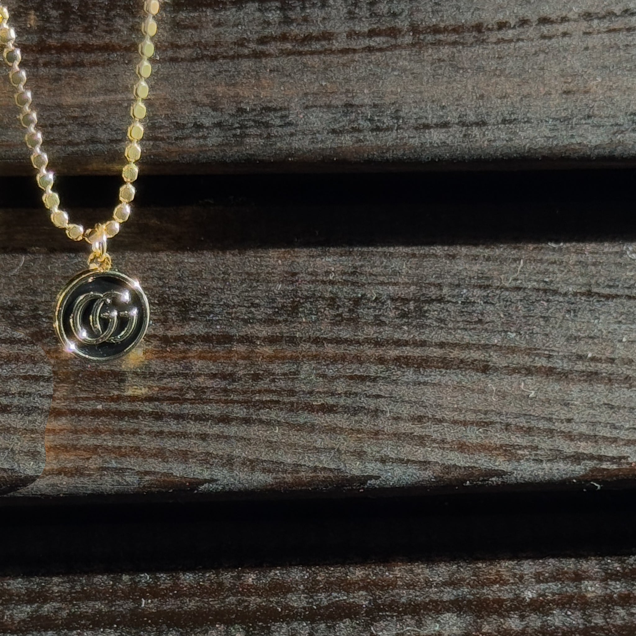 vintage mini gucci charm pendant necklace. black and gold. 